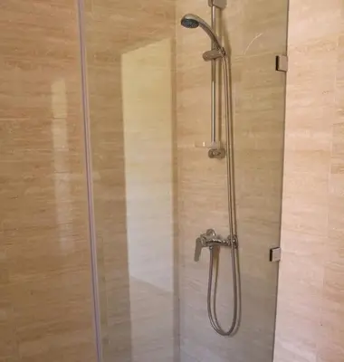 a shower with a glass door in a bathroom at BEL APPART FONCTIONNEL PRESTIGIA GOLF MARRAKECH in Marrakech