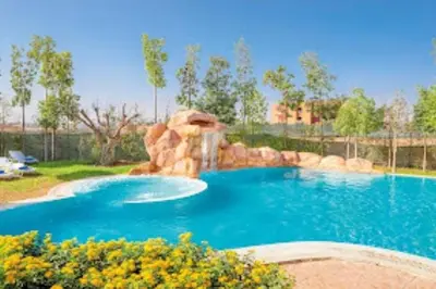 a pool with a waterfall and a water slide at Appartement Privé 1 Chambre Vizir Center Marrakech in Marrakech