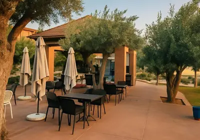 a patio with tables and chairs and umbrellas at Vizir appart A112 in Marrakech