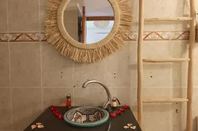 a bathroom with a sink and a mirror at RIAD CHOUKRI in Marrakech