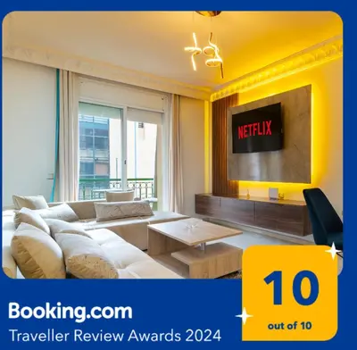 a living room with a couch and a tv at Gueliz Great Apt with Pool Self Check In 24 7 Security in Marrakech