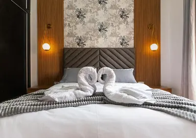 two swans towels are sitting on a bed at Gueliz Great Apt with Pool Self Check In 24 7 Security in Marrakech