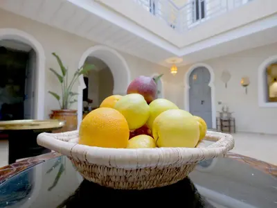 a basket of fruit sitting on top of a table at Riad Celema & Spa in Marrakech