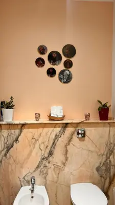 a bathroom with a sink and a toilet with plates on the wall at Très joli Appart à la palmeraie coup de cœur in Marrakech