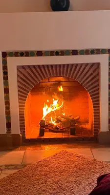 a brick oven with a fire in it at Très joli Appart à la palmeraie coup de cœur in Marrakech