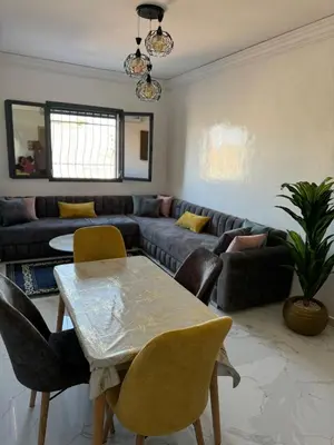 a living room with a couch and a table and chairs at Marrakesh manara in Marrakech