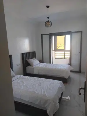 a bedroom with two beds and a window at Marrakesh manara in Marrakech