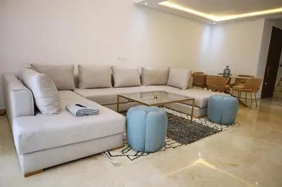 a living room with a couch and a table at Menara Duplex in Marrakech
