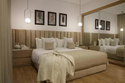 a bedroom with two beds and a large mirror at S_house in Marrakech