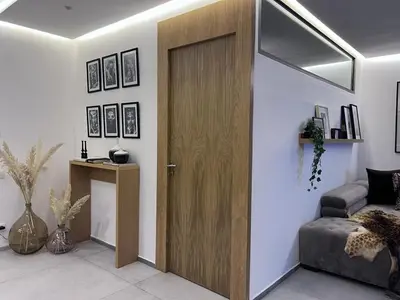 a wooden door in a living room with a couch at S_house in Marrakech