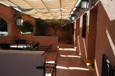 an outdoor patio with awning and tables and chairs at GREEN HOUSE in Marrakech