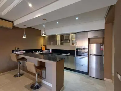 a large kitchen with a large counter and stainless steel appliances at stylish appartment heart of gueliz in Marrakech