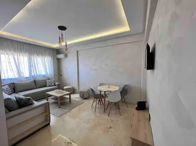 a living room with a couch and a table at NOUR appartement in Marrakech