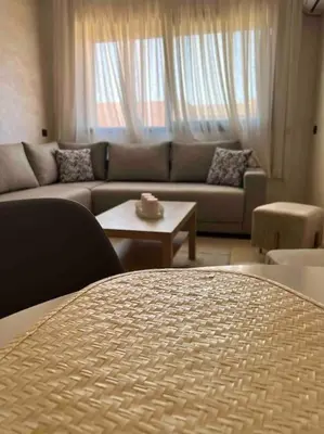 a living room with a couch and a table at NOUR appartement in Marrakech