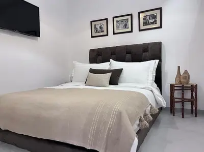a bedroom with a large bed with a tv on the wall at S_house in Marrakech