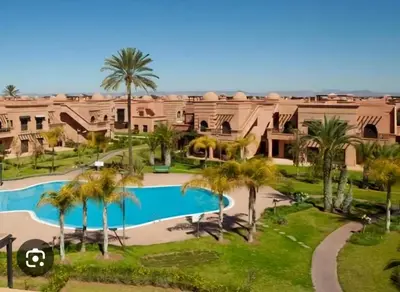 an aerial view of a resort with a swimming pool and palm trees at maison gueliz in Marrakech