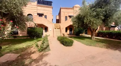 a house with a walkway in front of a yard at maison gueliz in Marrakech