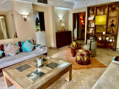 a living room with a couch and a coffee table at Villa Agdal in Marrakech