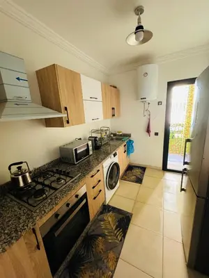 a kitchen with a stove top oven next to a sink at Glorieux appartement à gueliz in Marrakech