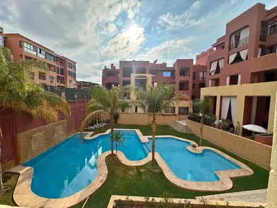 an apartment with a swimming pool in a city at Appartement calme, Guéliz in Marrakech