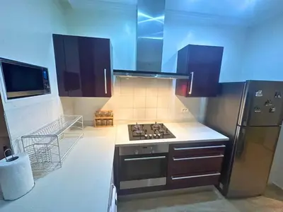 a kitchen with a stove and a refrigerator at Appartement calme, Guéliz in Marrakech