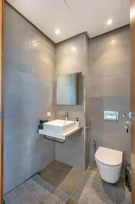 a bathroom with a sink and a toilet and a mirror at Duplex de Luxe Victor Hugo Gueliz in Marrakech