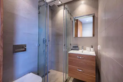 a bathroom with a shower and a toilet and a sink at Duplex de Luxe Victor Hugo Gueliz in Marrakech