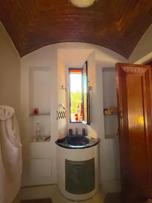 a bathroom with a sink and a window at Superbe villa avec piscine privée - Golf Amelkis in Marrakech