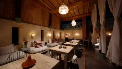 a living room with couches and tables and chairs at Riad Chambres D'Amis Marrakech in Marrakech