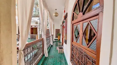 a hallway of a house with a green floor at Riad Chambres D'Amis Marrakech in Marrakech