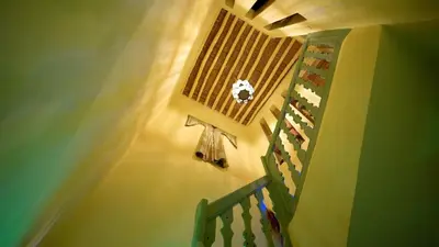 a room with a staircase with a window and a stair rail at Riad Chambres D'Amis Marrakech in Marrakech