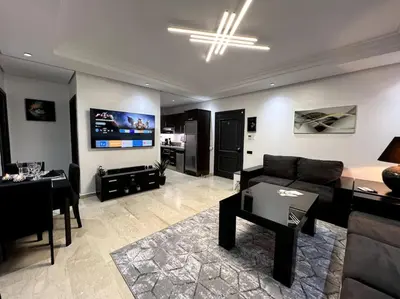 a living room with a couch and a table at Appartement Bagatelle in Marrakech