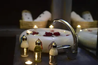 a bathroom sink with lit candles and a sink with a sink at Riad Iklil in Marrakech