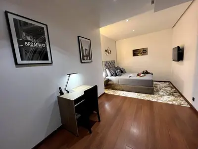 a bedroom with a bed and a desk and a bed sidx sidx sidx at Luxury apartment in center of gueliz in Marrakech