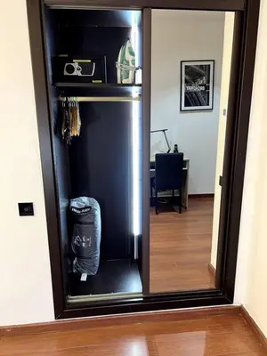 a black refrigerator in a room with a mirror at Luxury apartment in center of gueliz in Marrakech