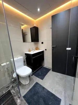 a bathroom with a toilet and a sink and a shower at Luxury apartment in center of gueliz in Marrakech