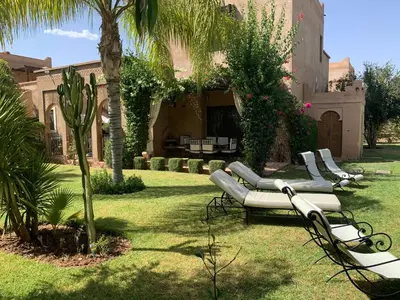 a row of chaise lounges in a yard at Rita House - Le Petit Paradis sur Terre in Douar Caïd Layadi