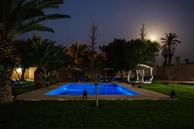 a swimming pool in a park at night at Villa Warhol Marrakech in Marrakech