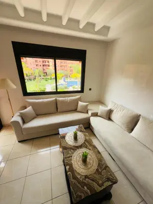 a living room with a couch and a table at Appartement Marrakech With Pool and View in Marrakech