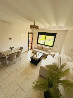 a living room with a couch and a table at Appartement Marrakech With Pool and View in Marrakech