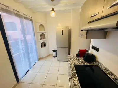 a kitchen with a refrigerator and a tile floor at Appartement Marrakech With Pool and View in Marrakech
