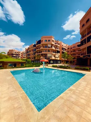 a large swimming pool in front of a building at Appartement Marrakech With Pool and View in Marrakech