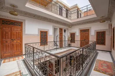 an ornate staircase in a house with wooden doors at Riad Albaraka in Marrakech