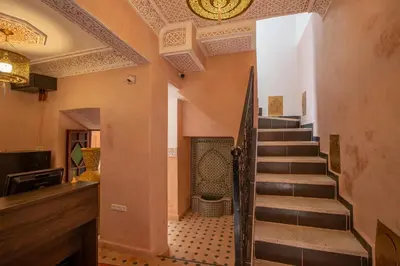 a hallway with a staircase in a house at Riad Albaraka in Marrakech