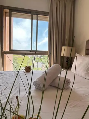 a bedroom with a bed with a large window at Appt Premium 3 rooms with big terrace at Prestigia Marrakech in Marrakech