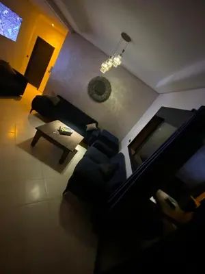 a living room with a couch and a table at Appartement véranda marrakech in Marrakech