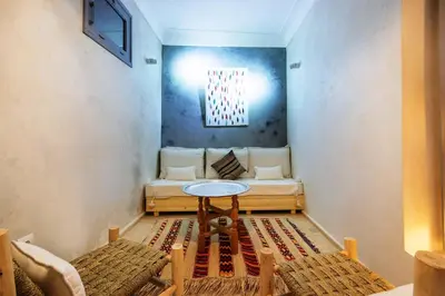 a living room with a table and a couch at Riad Berrima - Breakfast - 10mn from Jamaa Al Fna in Marrakech