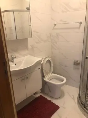 a white bathroom with a sink and a toilet at appartement center de Guéliz avec piscine in Marrakech