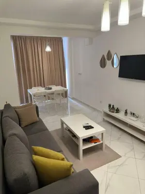 a living room with a couch and a table at appartement center de Guéliz avec piscine in Marrakech