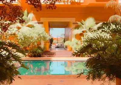 a house with a swimming pool and some plants at Appartement spacieux in Marrakech